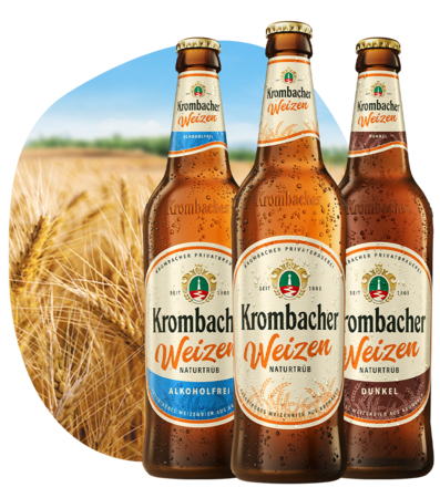 Krombacher Weizen Alkoholfrei, Naturtrüb und Dunkel vor einem Weizenfeld.