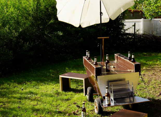 Ein weißer Sonnenschirm über den fertig gebauten Bierwagen mit Bierflaschenhalterungen.