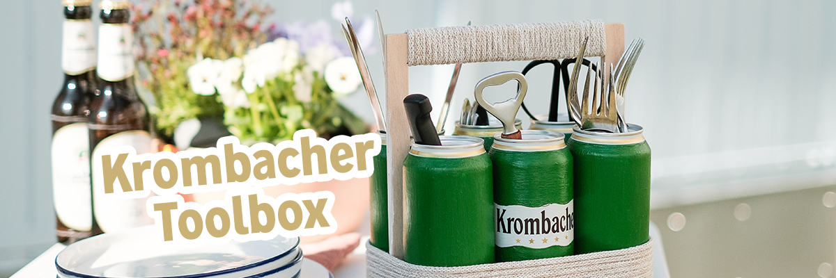 Grün angestrichene Krombacher Pilsdosen mit Text: Krombacher Toolbox.