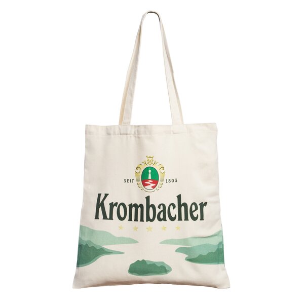 Beiger Jutebeutel mit grünem Krombacher-Logo, Text 'Krombacher' und Landschaftsmotiv in Grüntönen.
